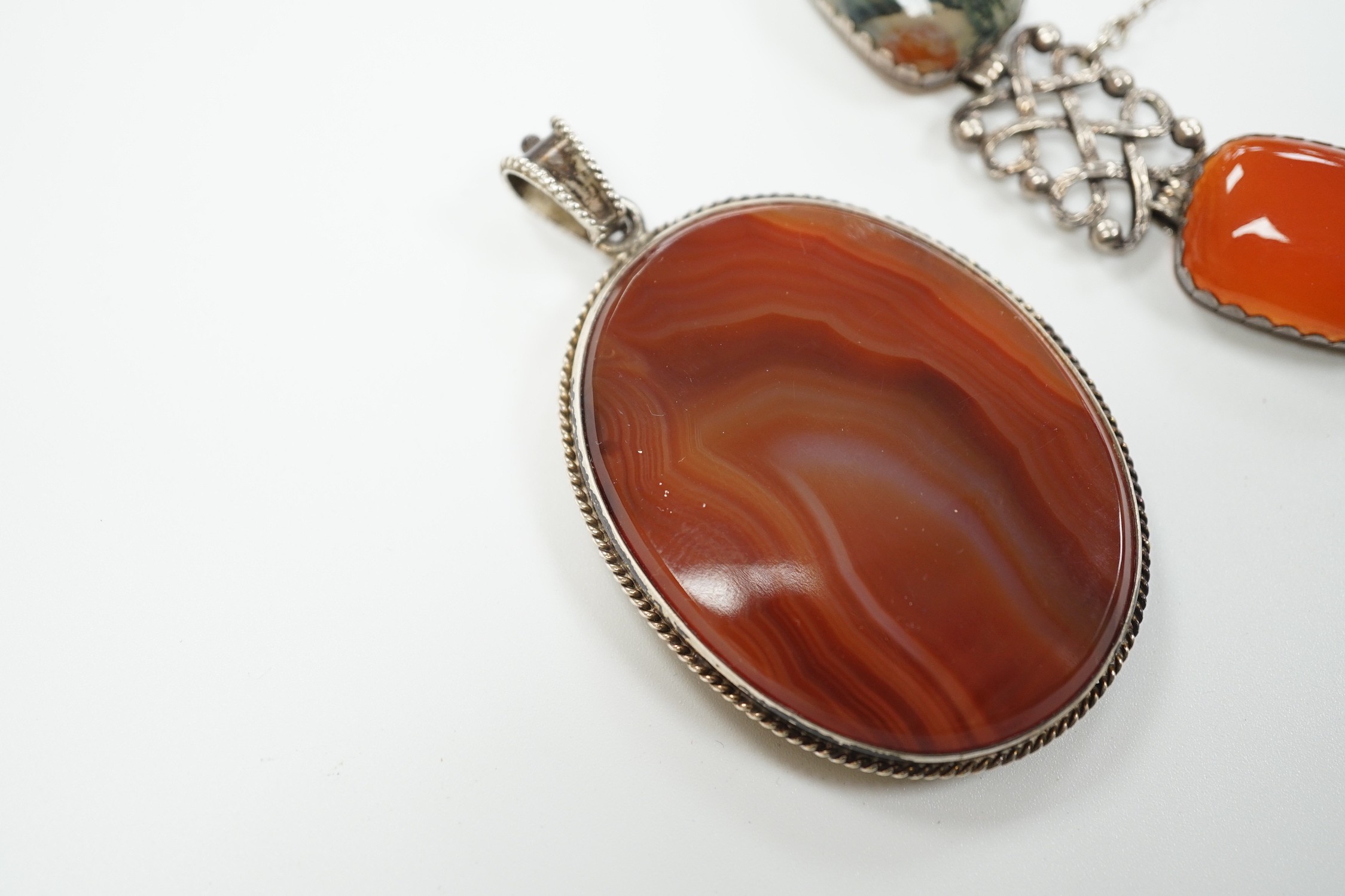 A pierced white metal and four stone agate set bracelet, 18.5cm and a white metal and banded agate set oval pendant.
